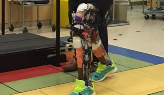 Children with cerebral palsy practice walk with a robotic exoskeleton at the National Institutes of Health&#39;s Clinical Center Department of Rehabilitation Medicine in Bethesda, Maryland. (National Institutes of Health)
