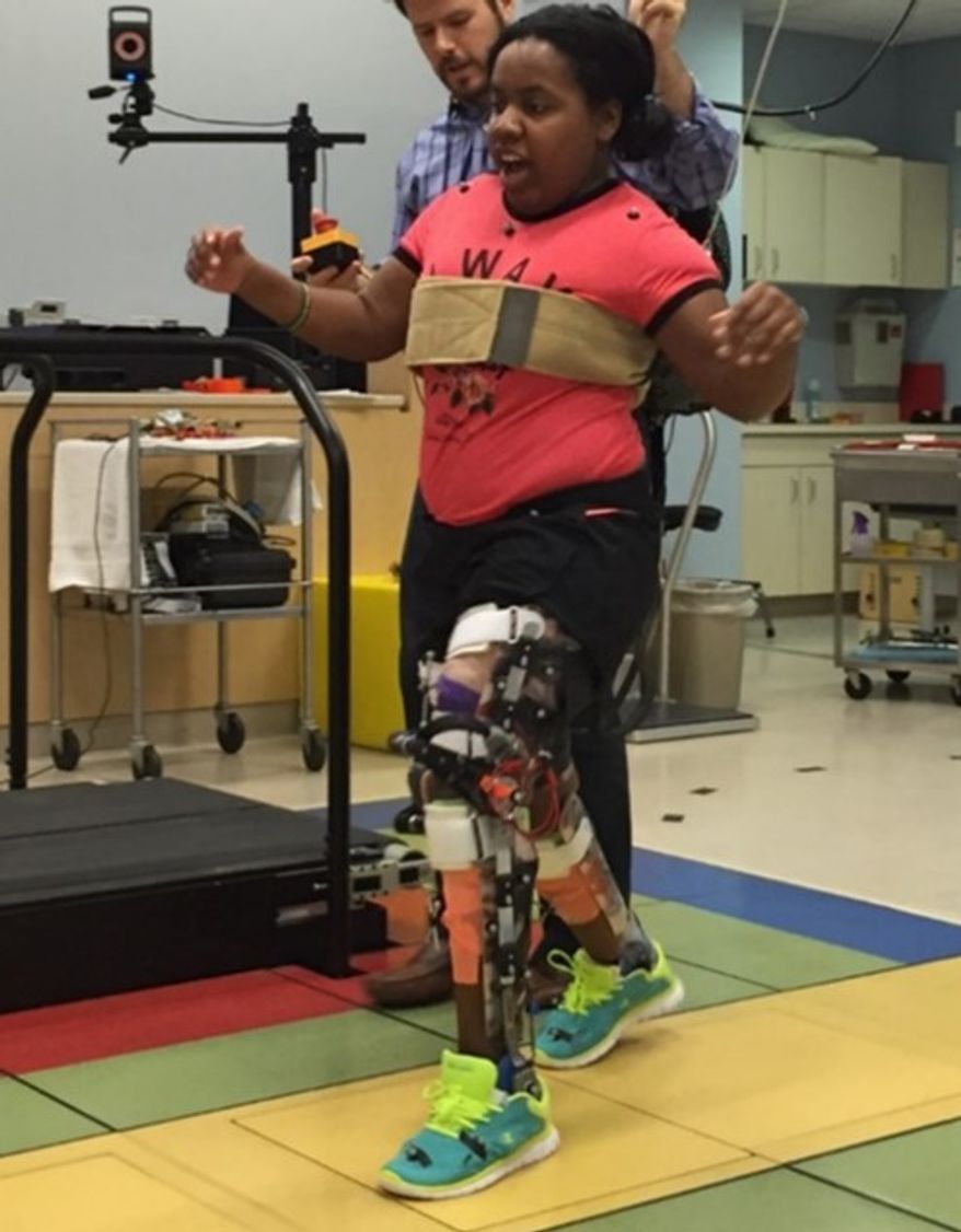 Children with cerebral palsy practice walk with a robotic exoskeleton at the National Institutes of Health's Clinical Center Department of Rehabilitation Medicine in Bethesda, Maryland. (National Institutes of Health)