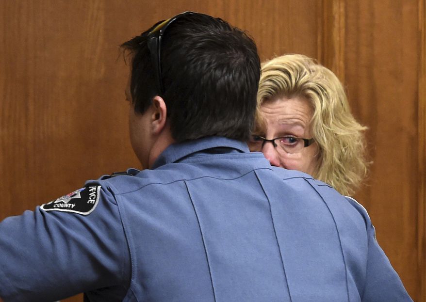 Monica Burke looks back at her family as she is taken into custody in a Boulder, Colo., courtroom on Friday, Aug. 25, 2017. The former school bus aide was sentenced to 20 months of prison and 5 years of probation for physically and verbally abusing a disabled student while she worked as a bus assistant for the St. Vrain Valley School District. (Cliff Grassmick/Daily Camera via AP, Pool)