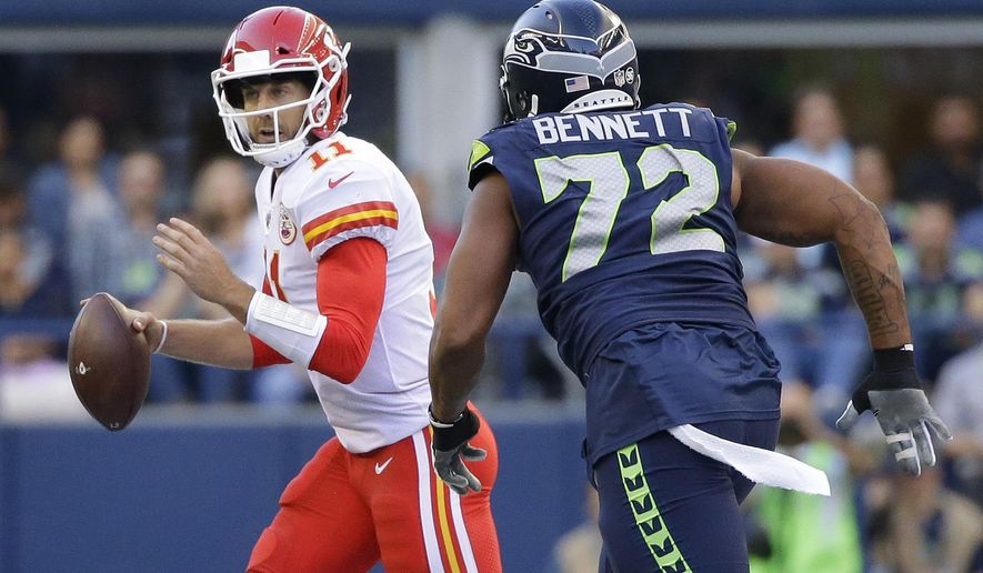 Seattle Seahawks defensive end Michael Bennett (72) pressures Kansas City Chiefs quarterback Alex Smith during the first half of an NFL football preseason game, Friday, Aug. 25, 2017, in Seattle. (AP Photo/Elaine Thompson)