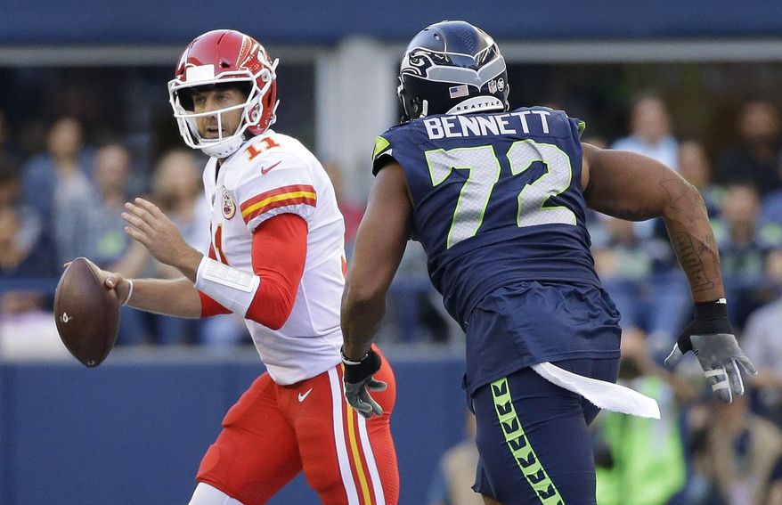 Seattle Seahawks defensive end Michael Bennett (72) pressures Kansas City Chiefs quarterback Alex Smith during the first half of an NFL football preseason game, Friday, Aug. 25, 2017, in Seattle. (AP Photo/Elaine Thompson)