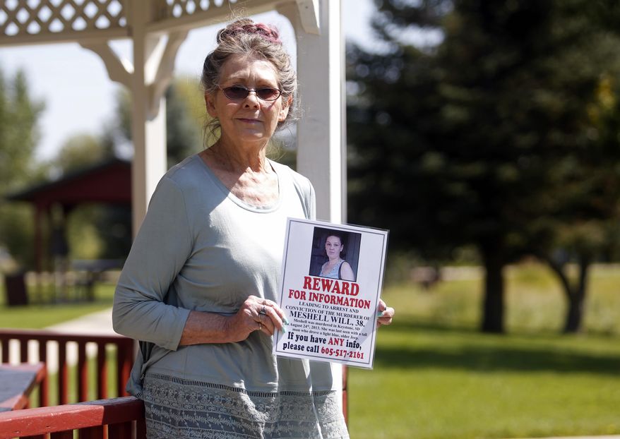 In this Aug. 22. 2017, photo Nancy Herman, of Custer S.D., holds a reward poster for information about the death of her friend Meshell Will. Herman has put up posters, saved money for a reward and created a Facebook page to gather information about Will’s suspicious death. (Chris Huber/Rapid City Journal via AP)