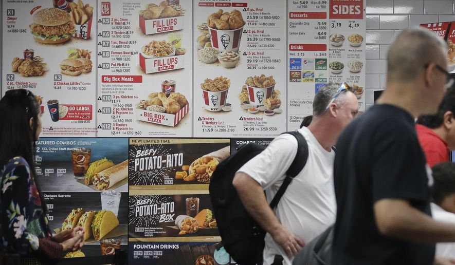 In this Aug. 24, 2017 photo, a KFC menu displays meal selections with calorie counts, in New York. As New York City battles in court over its pioneering rules requiring some restaurants, grocery stores and other eateries to post calorie counts, scientists are trying to judge whether the city&#39;s system has achieved a goal of getting people to change bad eating habits. (AP Photo/Bebeto Matthews)