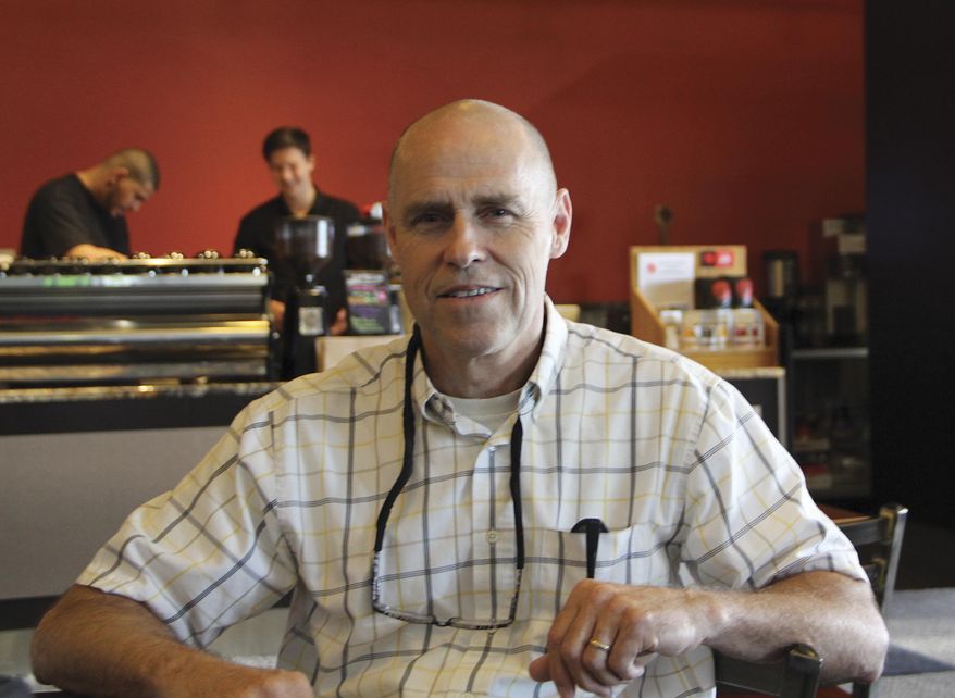 ADVANCE FOR WEEKEND AUG. 26-27 AND THEREAFTER - In this Aug. 4, 2017 photo, Alaska Professional Janitorial owner Curtis Lucas, poses at a cafe in Anchorage, Alaska. Lucas couldn't find anyone to fill one of his floor-cleaning jobs, so he invented a robot to do the work instead. (Naomi Klouda/Alaska Journal of Commerce via AP)