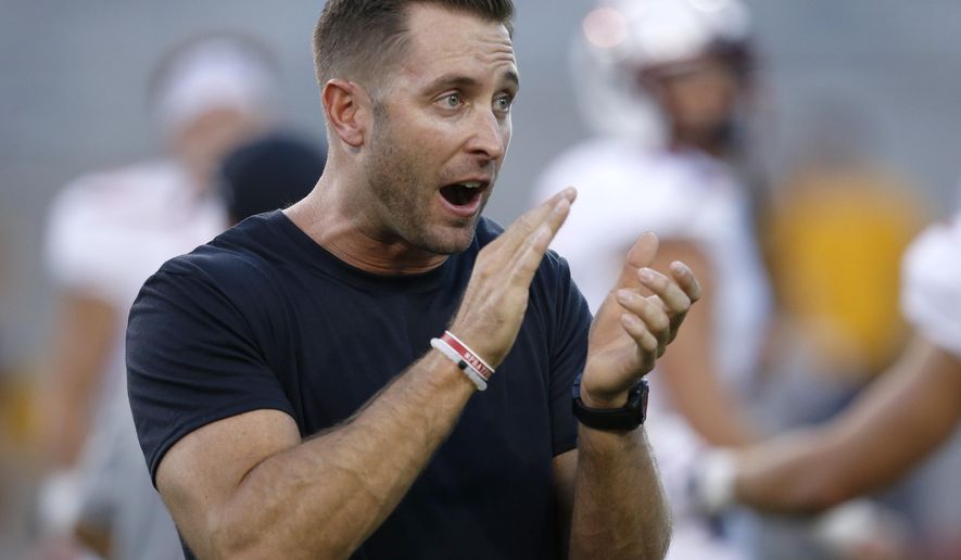 File- This Sept. 10, 2016, file photo shows Texas Tech head coach Kliff Kingsbury applauding as they warm up prior to an NCAA college football  in Tempe, Ariz. Leach’s former Tech quarterbacks are gaining prominence as coaches at Big 12 programs. Lincoln Riley recently was promoted from offensive coordinator to head coach at Oklahoma. Kingsbury has been the head coach at Texas Tech since 2013, and his offenses have been nearly unstoppable. Sonny Cumbie is entering his fourth season as TCU’s co-offensive coordinator, and his units with quarterback Trevone Boykin were among the best in college football. (AP Photo/Ross D. Franklin, File)