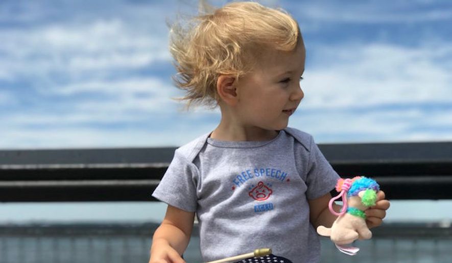 The American Civil Liberties Union tweeted this photo Wednesday of a white baby holding a U.S. flag. (ACLU)