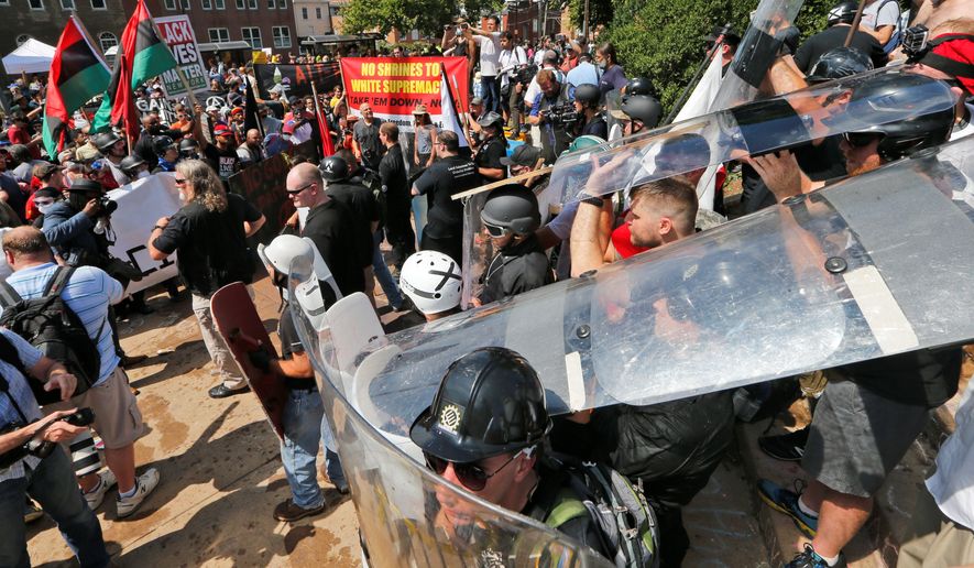 White nationalist demonstrators use shields as they clash with counter demonstrators at the entrance to Lee Park in Charlottesville, Virginia, on Aug. 12. (Associated Press)