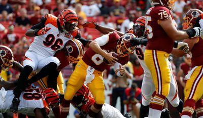 Washington Redskins quarterback Kirk Cousins is sacked by the Cincinnati Bengals in the first half of their preseason game on Sunday. Cousins was sacked twice, both times on third down, where the Redskins converted only 4-of-13 opportunities in the 23-17 victory. (Associated Press)