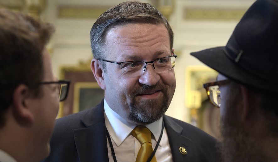 Deputy assistant to President Trump, Sebastian Gorka, talks with people in the Treaty Room in the Eisenhower Executive Office Building on the White House complex in Washington during a ceremony commemorating Israeli Independence Day. White House national security aide Sebastian Gorka tells The Associated Press he has resigned from his position, Friday, Aug. 25, 2017. (AP Photo/Susan Walsh, File)