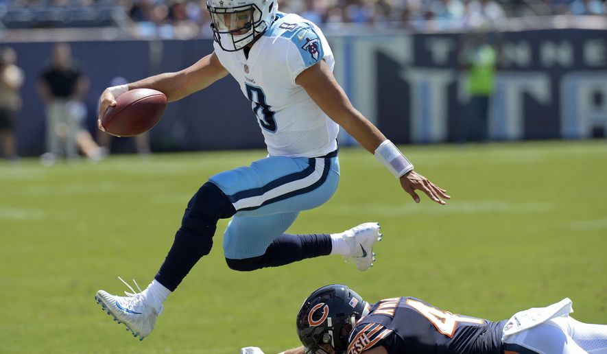 Tennessee Titans quarterback Marcus Mariota (8) leaps over Chicago Bears inside linebacker Nick Kwiatkoski (44) in the first half of an NFL football preseason game Sunday, Aug. 27, 2017, in Nashville, Tenn. (AP Photo/Mark Zaleski)