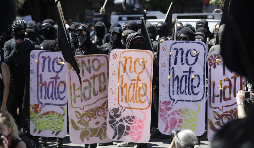 Demonstrators hold shields during a free speech rally Sunday, Aug. 27, 2017, in Berkeley, Calif. Several thousand people converged in Berkeley Sunday for a &amp;quot;Rally Against Hate&amp;quot; in response to a planned right-wing protest that raised concerns of violence and triggered a massive police presence. Several people were arrested for violating rules against covering their faces or carrying items banned by authorities. (AP Photo/Marcio Jose Sanchez)