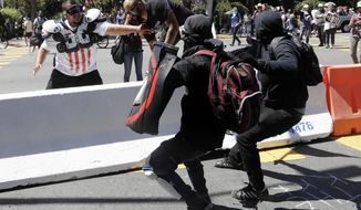 Demonstrator Joey Gibson, second from left, is chased by anti-fascists during a free speech rally Sunday, Aug. 27, 2017, in Berkeley, Calif. Several thousand people converged in Berkeley Sunday for a &amp;quot;Rally Against Hate&amp;quot; in response to a planned right-wing protest that raised concerns of violence and triggered a massive police presence. Several people were arrested for violating rules against covering their faces or carrying items banned by authorities. (AP Photo/Marcio Jose Sanchez)