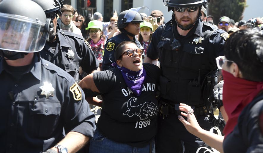 A demonstrator is arrested during a free speech rally Sunday, Aug. 27, 2017, in Berkeley, Calif. Several thousand people converged in Berkeley Sunday for a &amp;quot;Rally Against Hate&amp;quot; in response to a planned right-wing protest that raised concerns of violence and triggered a massive police presence. Several people were arrested for violating rules against covering their faces or carrying items banned by authorities. (AP Photo/Josh Edelson)