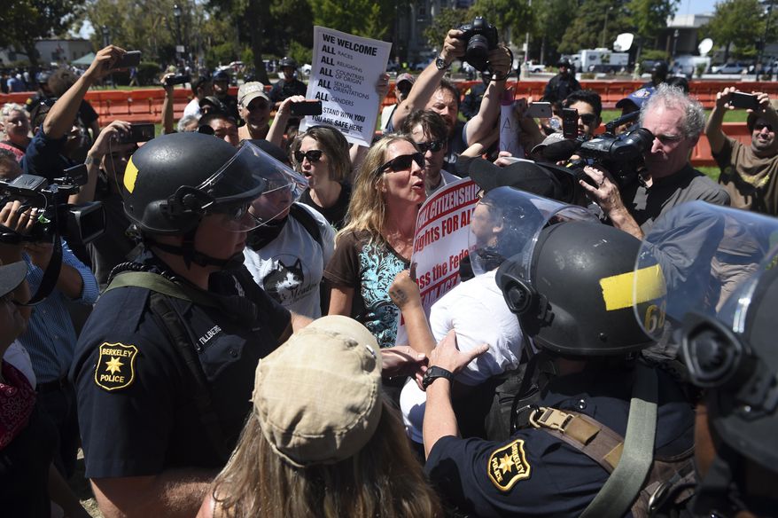 Demonstrators clash during a free speech rally Sunday, Aug. 27, 2017, in Berkeley, Calif. Several thousand people converged in Berkeley Sunday for a &amp;quot;Rally Against Hate&amp;quot; in response to a planned right-wing protest that raised concerns of violence and triggered a massive police presence. Several people were arrested for violating rules against covering their faces or carrying items banned by authorities. (AP Photo/Josh Edelson)