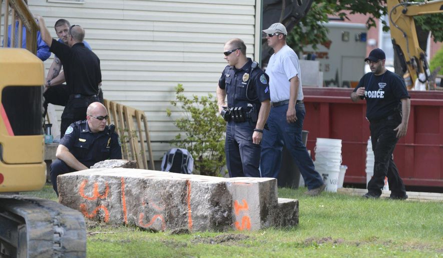 In this 2017 photo, police officers look over a slab of concrete pulled out of the basement of a home in Milton, Pa. Investigators hope cement taken from the Pennsylvania basement will solve the 1989 disappearance of Barbara Elizabeth Miller by determining if her remains were fed through wood chipper and then entombed there. Police said preliminary results showed the concrete contained wood chips and they’re testing for the remains of Miller. (Robert Inglies/The Daily Item via AP)