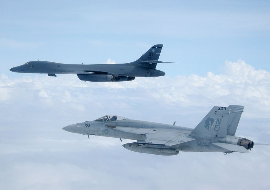 A B-1B Lancer from Andersen Air Force Base, Guam, and an F/A-18E Super Hornet assigned to the “Golden Dragons” of Strike Squadron (VFA) 192 fly over the aircraft carrier USS Carl Vinson (CVN 70). The B-1 is deployed in support of U.S. Pacific Command’s Continuous Bomber Presence (CBP) mission. In place since 2004, the CBP missions are conducted by U.S. Air Force bombers such as the B-1, B-52 Stratofortress and B-2 Spirit in order to provide non-stop stability and security in the Indo-Asia-Pacific region. The Carl Vinson Carrier Strike Group is on a western Pacific deployment as part of the U.S. Pacific Fleet-led initiative to extend the command and control functions of U.S. 3rd Fleet. (U.S. Navy photo by Lt. Robert Nordlund/Released)