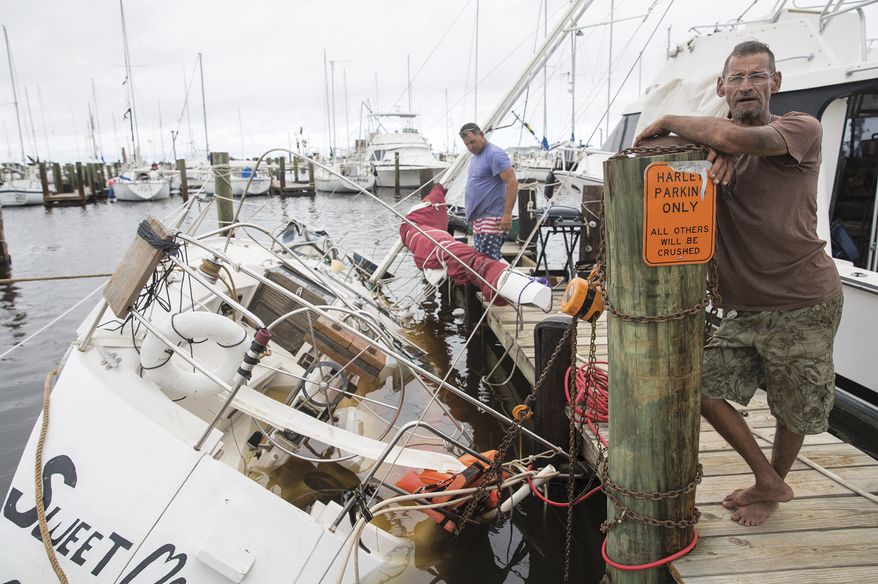 Mike Zbranek, 59, front, came from Lake City to help his brother, Robert, back, get his boat out of the water at the Rockport Marina in Texas Sunday, Aug. 27, 2017. The 38-foot boat sunk the night of Hurricane Harvey. (The Victoria Advocate via AP)