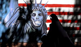 Graffiti art characterizing the Statue of Liberty is painted on the wall of the former U.S. Embassy in Tehran. Iranian-American businessman Siamak Namazi and his 81-year-old father, Baquer, are among several dual nationals detained in Iran. They learned last week that they had lost an appeal. (Associated Press/File)