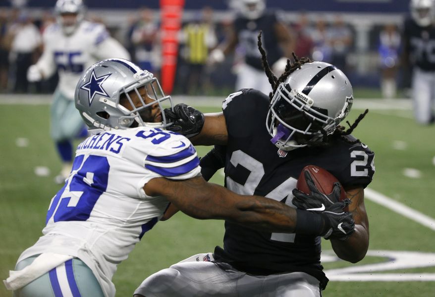 Dallas Cowboys linebacker Anthony Hitchens (59) tries to stop Oakland Raiders running back Marshawn Lynch (24) on a run in the first half of a preseason NFL football game, Saturday, Aug. 26, 2017, in Arlington, Texas. (AP Photo/Ron Jenkins)