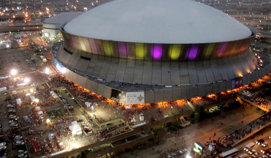 FILE - In this Jan. 7, 2008, file photo, color lights play on the Louisiana Superdome at twilight before the BCS championship college football game in New Orleans. The BYU-LSU game will be played Saturday, Sept. 2, 2017 at the Superdome in New Orleans after massive flooding in Houston from Hurricane Harvey forced it to be relocated from NRG Stadium. (AP Photo/Rob Carr, File)