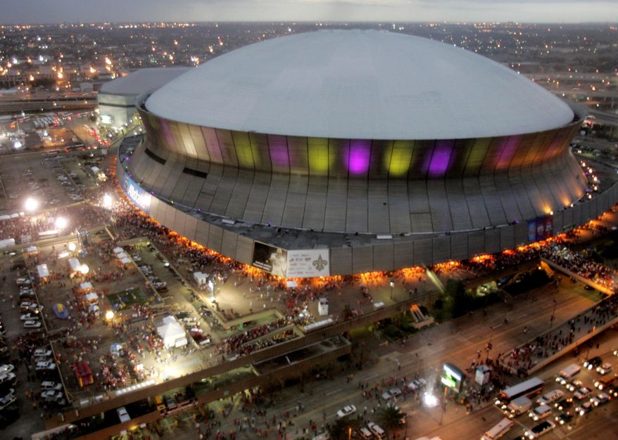 FILE - In this Jan. 7, 2008, file photo, color lights play on the Louisiana Superdome at twilight before the BCS championship college football game in New Orleans. The BYU-LSU game will be played Saturday, Sept. 2, 2017 at the Superdome in New Orleans after massive flooding in Houston from Hurricane Harvey forced it to be relocated from NRG Stadium. (AP Photo/Rob Carr, File)