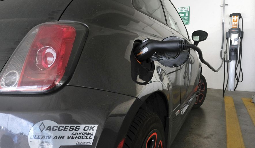 This April 25, 2016, photo shows an electric Fiat plugged into a charging station in a parking lot in Los Angeles. California could spend up to $3 billion under a bill that would widely expand its consumer rebate program for zero-emission vehicles. The Legislature is pushing forward a bill that could lift rebates from $2,500 to $10,000 or more for a compact electric car. Current rebates have done little to boost sales. (AP Photo/Richard Vogel)