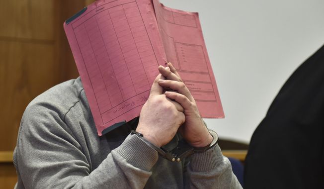 FILE - In this Feb. 26, 2015 file photo  former nurse Niels Hoegel., accused of multiple murder and attempted murder of patients, covering his face with a file at the district court in Oldenburg, Germany. German authorities say Monday Aug. 28, 2017  they now believe that a nurse who was convicted of killing patients with overdoses of heart medication killed at least 84 people. Niels Hoegel was convicted in 2015 of two murders and two attempted murders at a clinic in the northwestern town of Delmenhorst.  Oldenburg police chief Johann Kuehme said Monday authorities have now unearthed evidence of 84 killings. (Carmen Jaspersen/dpa via AP,file)