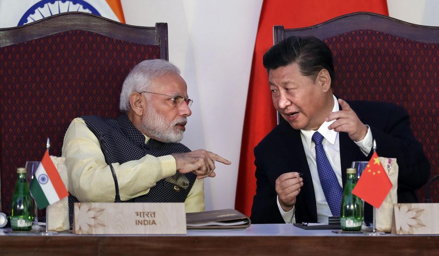 In this Oct. 16, 2016, file photo, Indian Prime Minister Narendra Modi, left, talks with Chinese President Xi Jinping at the BRICS summit in Goa, India. India and China have agreed to pull back their troops from a face-off in the high Himalayas where China, India and Bhutan meet, signaling a thaw in the monthslong standoff, India&#x27;s government said Monday, Aug. 28, 2017. (AP Photo/Manish Swarup, File)