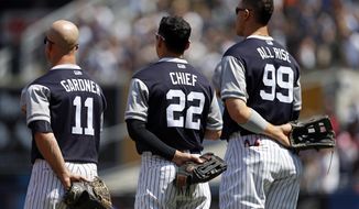 New York Yankees Brett Gardner (11), Yankees Jacoby Ellsbury (22) and Yankees Aaron Judge (99) stand for the national anthem prior to taking on the Seattle Mariners in a baseball game on Saturday, Aug. 26, 2017, in New York. (AP Photo/Adam Hunger)