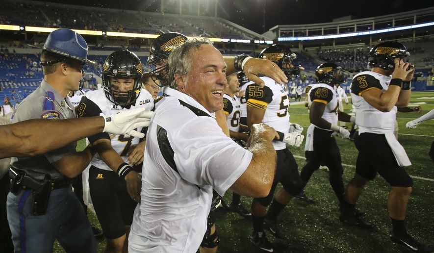 FILE - In this Sept. 3, 2016, file photo, Southern Mississippi head coach Jay Hopson, center, celebrates with his team after defeating Kentucky in an NCAA college football game, in Lexington, Ky. Southern Miss rallied for a stunning 44-35 win over Kentucky last year in Lexington. Now the Golden Eagles get a chance to make it two in a row _ and this time the game's at home in Roberts Stadium.(AP Photo/David Stephenson, File)