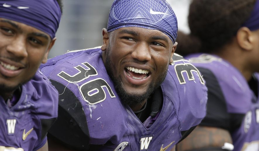 FILE - In this Sept. 3, 2016, file photo, Washington&#39;s Azeem Victor smiles on the sidelines during an NCAA college football game against Rutgers, in Seattle. Washington will be without Victor for the opener at Rutgers after he was suspended one game for a violation of team rules. Washington coach Chris Petersen announced Victor’s suspension but did not specify the violation. (AP Photo/Elaine Thompson, File)