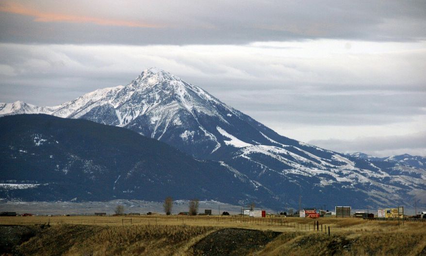 FILE - This Nov. 21, 2016, file photo shows Emigrant Peak towering over the Paradise Valley in Montana north of Yellowstone National Park, the day U.S. officials announced a ban on new mining claims across more than 30,000 acres in the area. U.S. Interior Secretary Ryan Zinke says he wants to speed up a proposal to block new gold mining claims on public lands near Yellowstone National Park and will consider blocking other types of mining. (AP Photo/Matthew Brown, File)