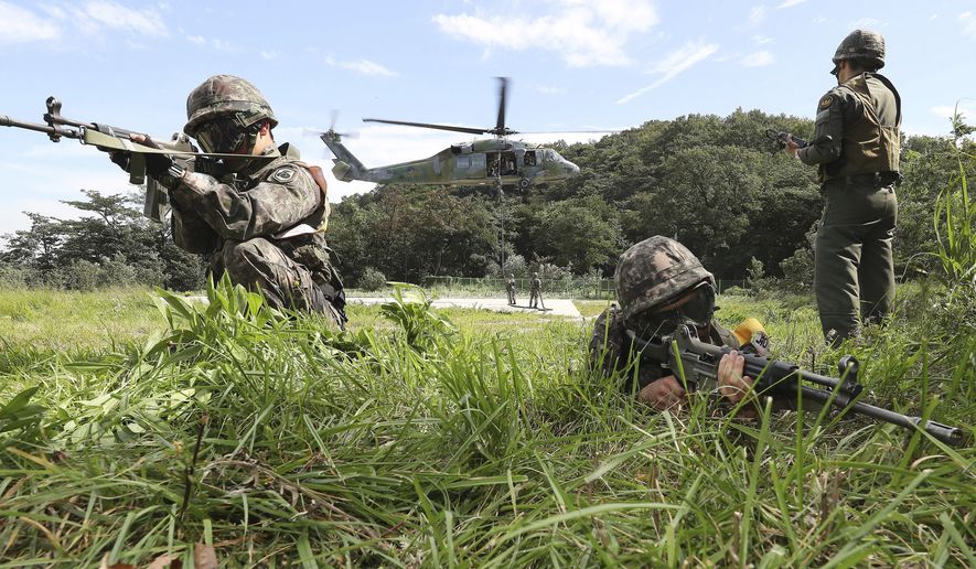 South Korean army soldiers aim their machine guns during the annual Ulchi Freedom Guardian exercise in Yongin, South Korea, Tuesday, Aug. 29, 2017. In a first, North Korea on Tuesday fired a midrange ballistic missile designed to carry a nuclear payload that flew over Japan and splashed into the northern Pacific Ocean, officials said. The aggressive missile launch — likely the longest ever from North Korea — over the territory of a close U.S. ally sends a clear message of defiance as Washington and Seoul conduct war games nearby. (Hong Gi-won/Yonhap via AP)