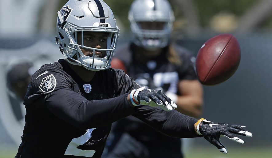In this Tuesday, June 13, 2017 file photo, Oakland Raiders cornerback Gareon Conley tosses a ball during NFL football practice at the team's training facility in Alameda, Calif. Oakland Raiders first-round pick Gareon Conley passed his physical and has been taken off the physically unable to perform list. Conley took part in practice Tuesday, Aug. 29, 2017 for the first time since injuring his shin during minicamp on June 13. (AP Photo/Ben Margot, File)