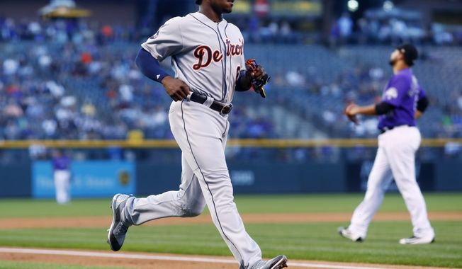 Detroit Tigers&#x27; Justin Upton, front, scores on a single hit by Nicholas Castellanos as Colorado Rockies starting pitcher Antonio Senzatela reacts in the background in the first inning of a baseball game Monday, Aug. 28, 2017, in Denver. (AP Photo/David Zalubowski)