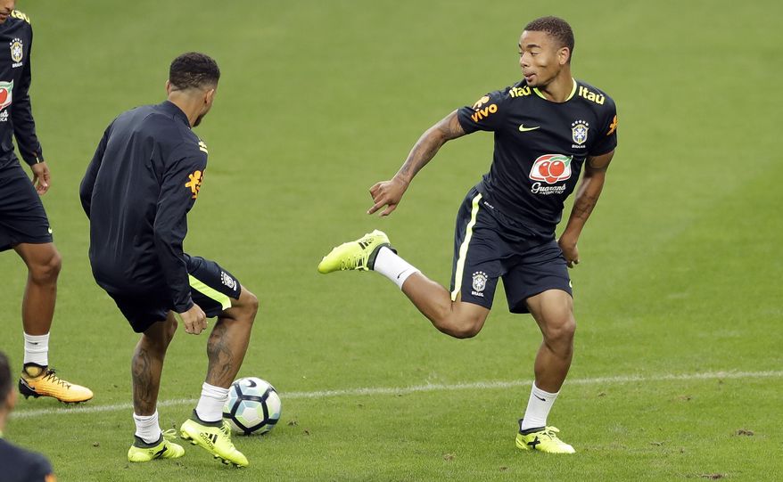 Brazil's Gabriel Jesus, right, and Taison train in Porto Alegre, Brazil, Wednesday, Aug. 30, 2017. Brazil will face Ecuador in a 2018 World Cup qualifying soccer match on Aug. 31. (AP Photo/Andre Penner)