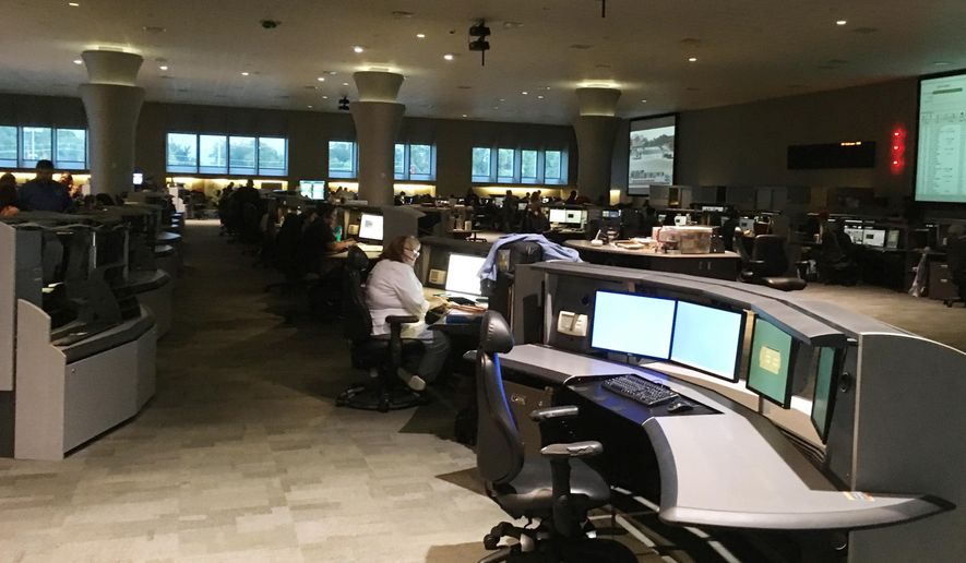 In this Tuesday, Aug. 29, 2017, photo, operators at the Houston Emergency Center answer calls for help to 911 in the aftermath of Hurricane Harvey in Houston. Several Nebraska counties, the entire state of South Dakota, southern Nevada and the cities of Del Rio and Kilgore, Texas, suffered 911 service outages Wednesday night. (AP Photo/Matt Sedensky)