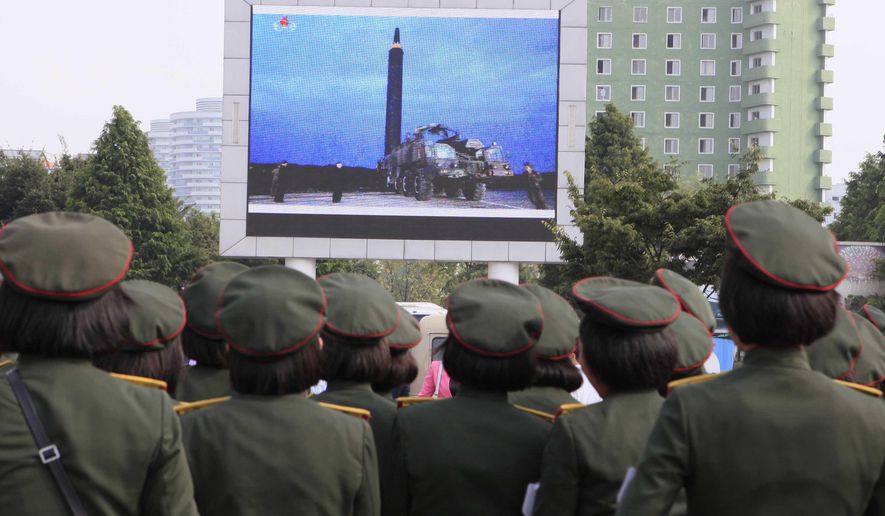 People fill the square of the main railway station to watch a televised news broadcast of the test-fire of an inter-continental ballistic rocket Hwasong-12, Wednesday, August 30, 2017, in Pyongyang, North Korea. By firing a missile over Japan and putting the Asia-Pacific, including U.S. territory Guam, on notice for more and more ambitious tests, the North has won itself greater space for more weapons tests Washington and Seoul see as provocative. (AP Photo/Kim Kwang Hyon)