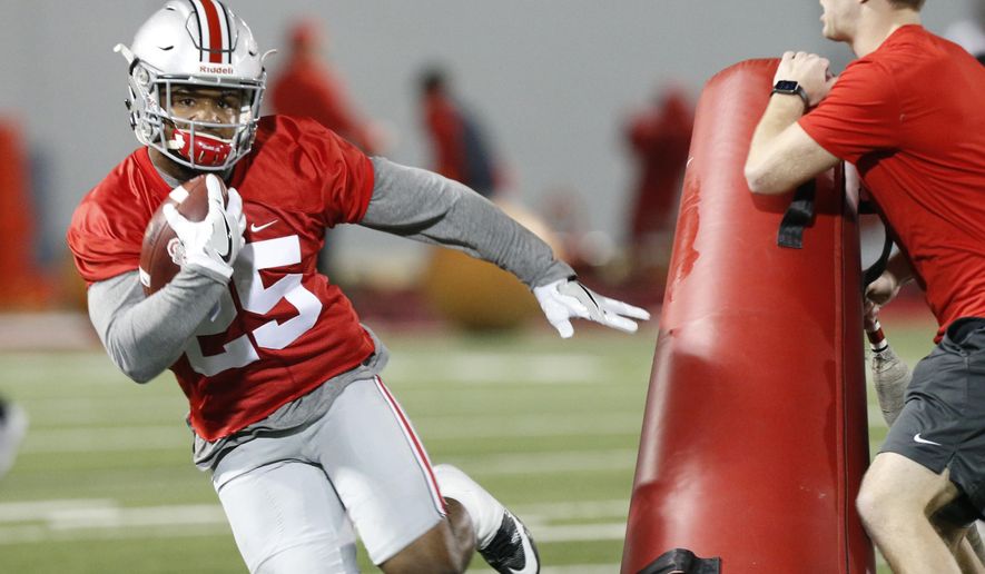 FILE - In this March 7, 2017, file photo, Ohio State running back Mike Weber runs a drill during their NCAA college football practice in Columbus, Ohio. Ohio State’s top running back, Weber, has been slowed by a hamstring injury over the last month, giving true freshman J.K. Dobbins a chance to take the majority of first-team snaps. He’s already No. 2 on the depth chart.(AP Photo/Jay LaPrete, File)