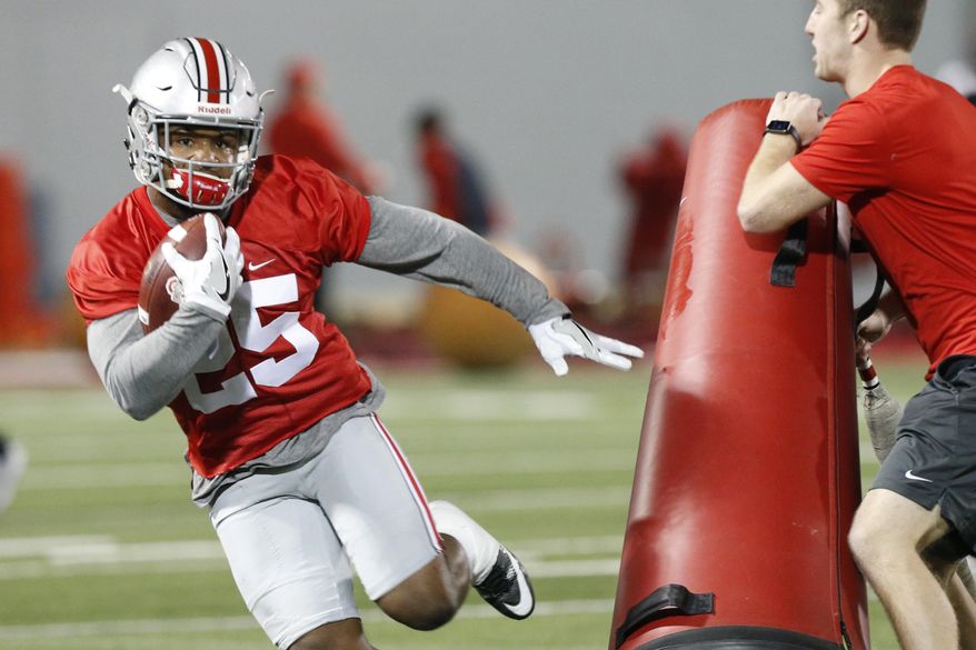 FILE - In this March 7, 2017, file photo, Ohio State running back Mike Weber runs a drill during their NCAA college football practice in Columbus, Ohio. Ohio State’s top running back, Weber, has been slowed by a hamstring injury over the last month, giving true freshman J.K. Dobbins a chance to take the majority of first-team snaps. He’s already No. 2 on the depth chart.(AP Photo/Jay LaPrete, File)