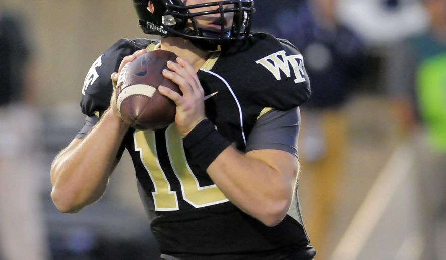 FILE - In this Sept. 13, 2014, file photo, Wake Forest quarterback John Wolford (10) looks for an open receiver during an NCAA football game against Utah State, in Logan, Utah. Wolford is ready to earn his place in Wake Forest history. He will become the program's first quarterback to start four consecutive season openers when the Demon Deacons take on Presbyterian. (AP Photo/Eli Lucero, File)