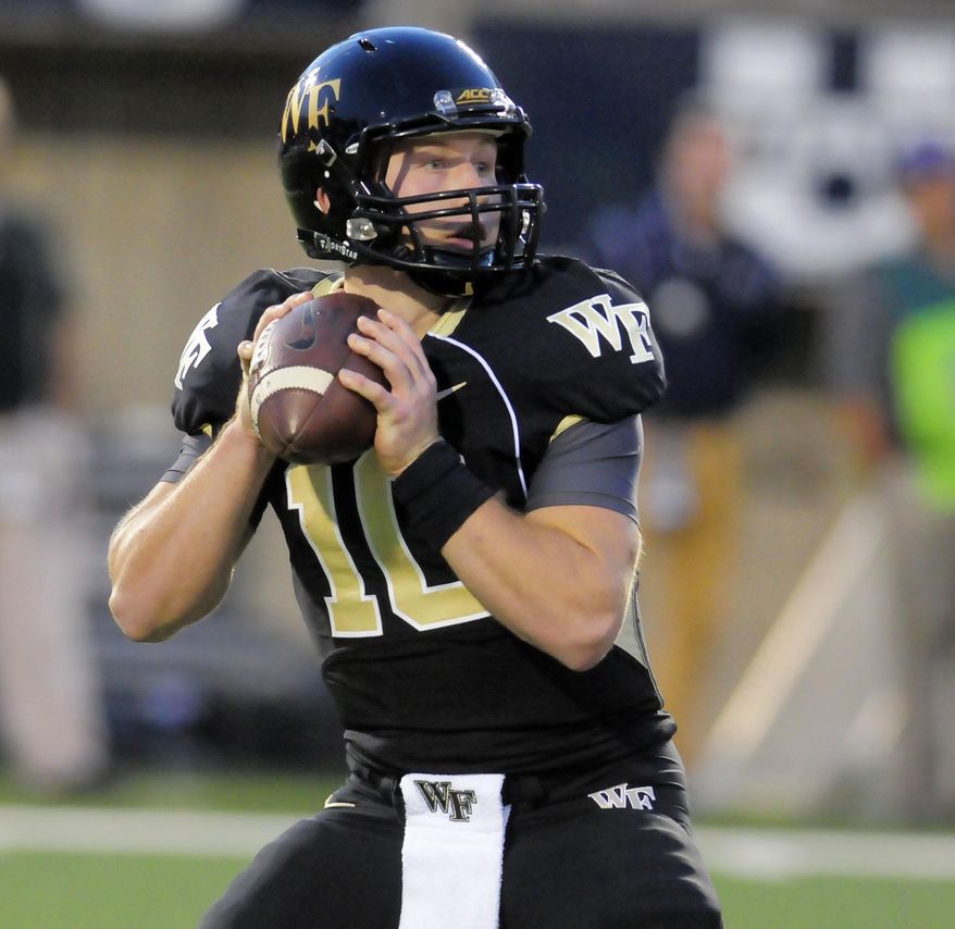 FILE - In this Sept. 13, 2014, file photo, Wake Forest quarterback John Wolford (10) looks for an open receiver during an NCAA football game against Utah State, in Logan, Utah. Wolford is ready to earn his place in Wake Forest history. He will become the program's first quarterback to start four consecutive season openers when the Demon Deacons take on Presbyterian. (AP Photo/Eli Lucero, File)