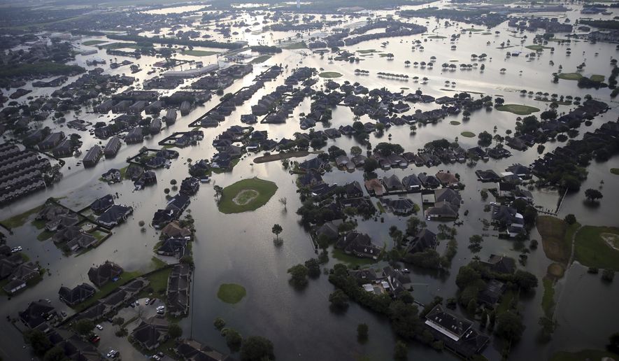 Floodwaters from Tropical Storm Harvey surround homes in Port Arthur, Texas, Thursday, Aug. 31, 2017. (AP Photo/Gerald Herbert)