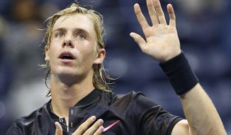 Denis Shapovalov, of Canada, pats his chest over his heart as he waves to fans after upsetting the No. 8 seed, Jo-Wilfried Tsonga, of France, 6-4, 6-4, 7-6 (3) at the U.S. Open tennis tournament in New York, Wednesday, Aug. 30, 2017. (AP Photo/Kathy Willens)
