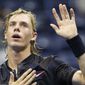 Denis Shapovalov, of Canada, pats his chest over his heart as he waves to fans after upsetting the No. 8 seed, Jo-Wilfried Tsonga, of France, 6-4, 6-4, 7-6 (3) at the U.S. Open tennis tournament in New York, Wednesday, Aug. 30, 2017. (AP Photo/Kathy Willens)