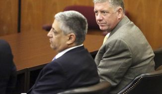 In a Dec. 22, 2016 photo, Rep. Jim Merrill, right, and one of his lawyers Rep. Leon Stavrinakis wait for the start of Merrill&#39;s bond hearing in a Columbia, S.C. courtroom. A hearing has been set for Friday, Sept 1, 2017, for Merrill, one of two former South Carolina House majority leaders accused of corruption, a special prosecutor investigating potential Statehouse corruption announced Thursday, Aug. 31, 2017. (Brad Nettles/The Post And Courier via AP)