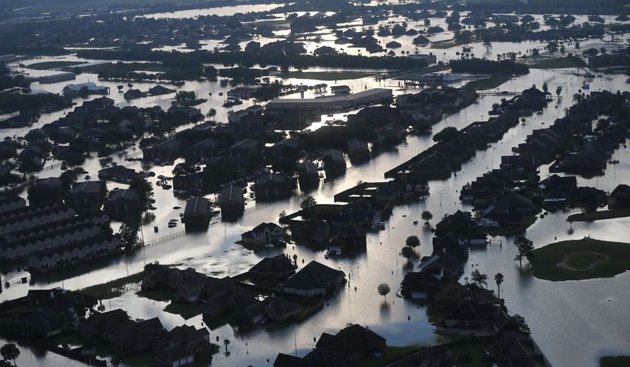 Floodwaters from Tropical Storm Harvey surround homes in Port Arthur, Texas, Thursday, Aug. 31, 2017. (AP Photo/Gerald Herbert)
