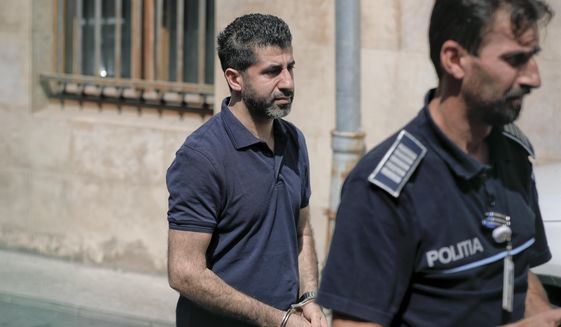 Tavan Resit, a Turkish businessman the United States wants to extradite on suspicion of supporting Iran&#x27;s military procurement plan, walks handcuffed after asking a Romanian court to free him from arrest, in Bucharest, Romania, Thursday, Aug. 31, 2017. Resit was arrested on June 8 in Romania, where he had traveled to meet with U.S. officials. (AP Photo/Vadim Ghirda)