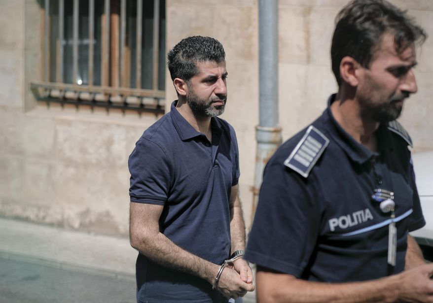 Tavan Resit, a Turkish businessman the United States wants to extradite on suspicion of supporting Iran&#39;s military procurement plan, walks handcuffed after asking a Romanian court to free him from arrest, in Bucharest, Romania, Thursday, Aug. 31, 2017. Resit was arrested on June 8 in Romania, where he had traveled to meet with U.S. officials. (AP Photo/Vadim Ghirda)