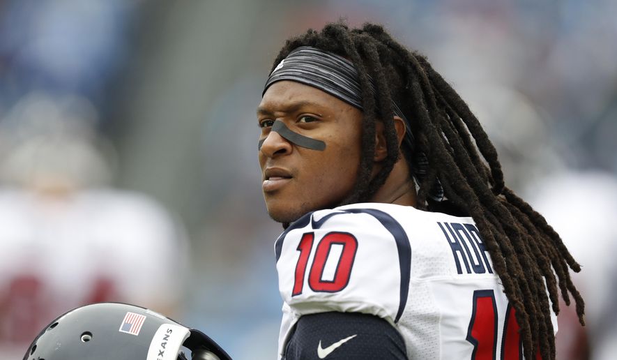 FILE - In this Jan. 1, 2017, file photo, Houston Texans wide receiver DeAndre Hopkins warms up before an NFL football game against the Tennessee Titans in Nashville, Tenn. A person familiar with the negotiations says the Texans and Hopkins have agreed to a five-year, $81 million contract extension. The person spoke to The AP on the condition of anonymity because the deal had not yet been announced by the teams. (AP Photo/Weston Kenney, File)
